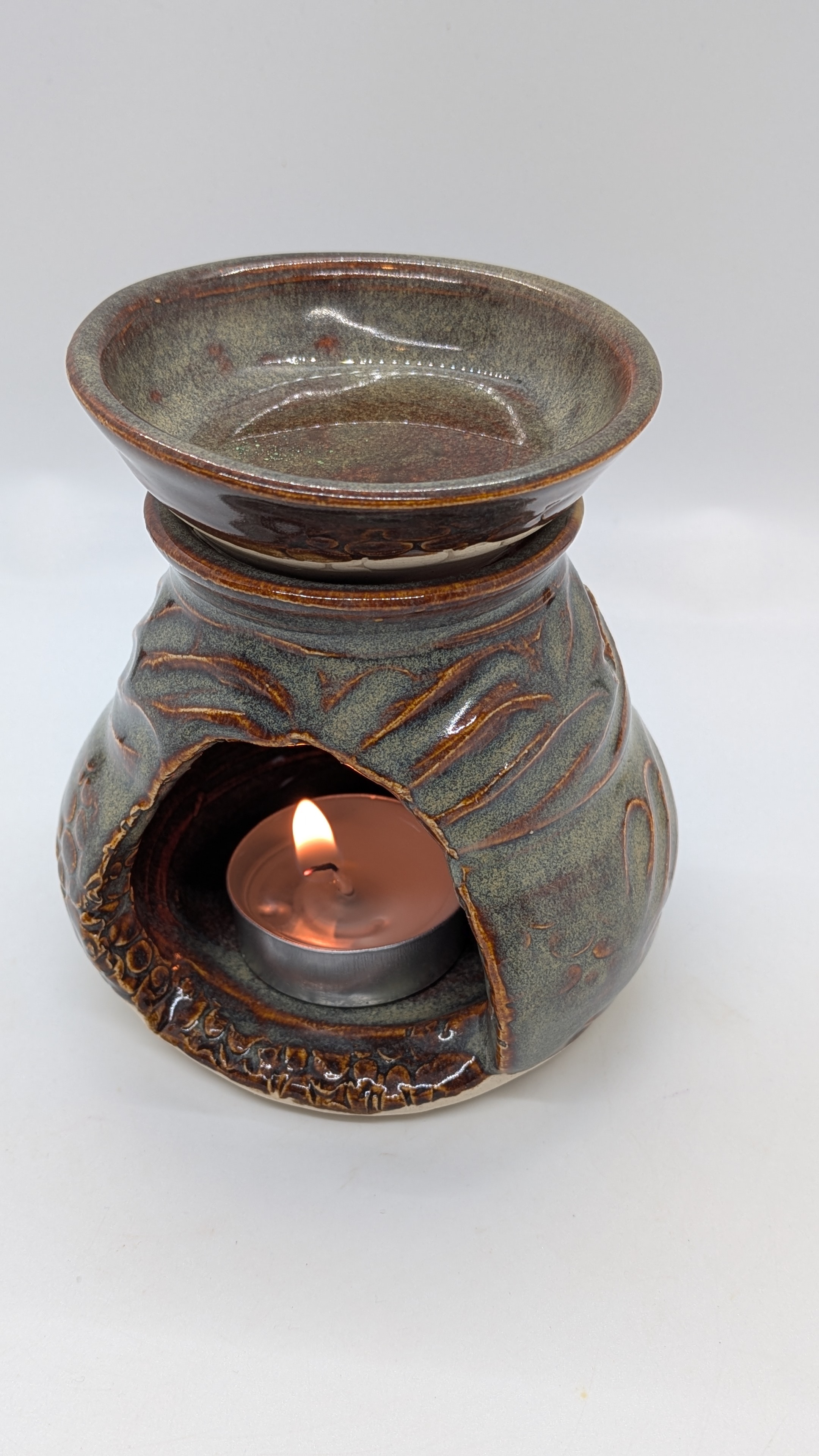 Wax Warmer - This adorable little wax warmer adds soft ambiance to any space. The gray glaze features undertones of greens and blues, and breaks to brown over the hand-carved texture. 

The top is separate from the bottom so you can easily lift it off for cleaning. Both parts were wheel-thrown, and then textured.

 - 30